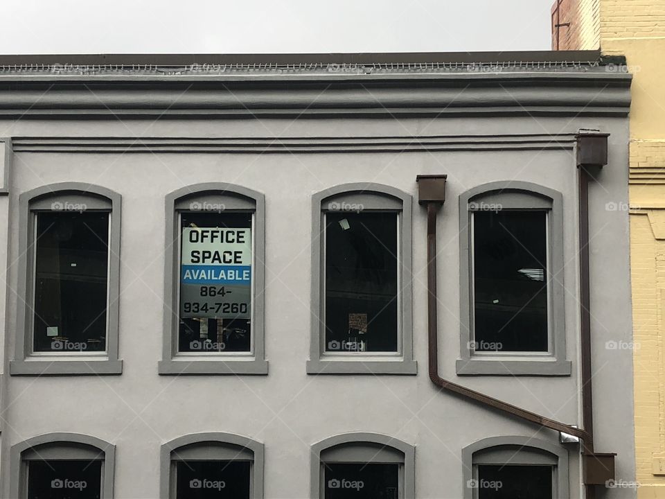 Geometric city building with sign in window.