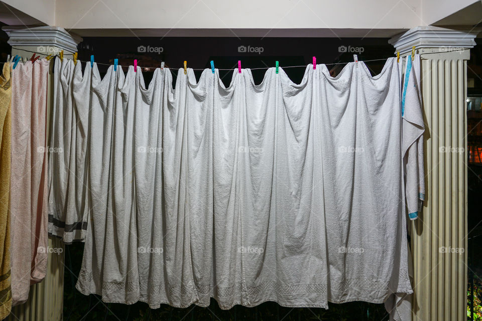 view of the household, white towels dries on ropes on clothespins