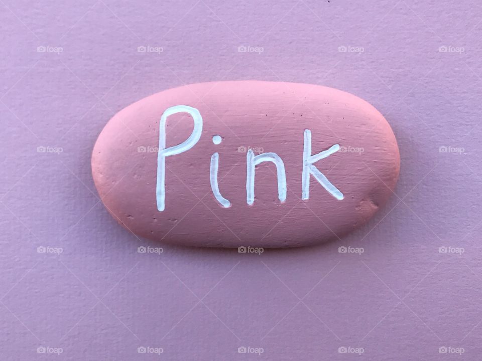 Pink colored stone over a pink sheet 