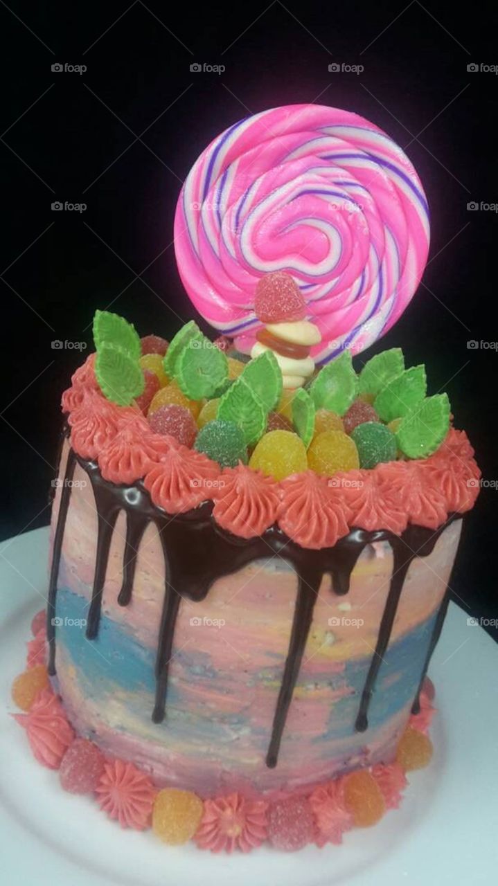 Sweet cake with candies and garnished with jelly beans, with chocolate bath