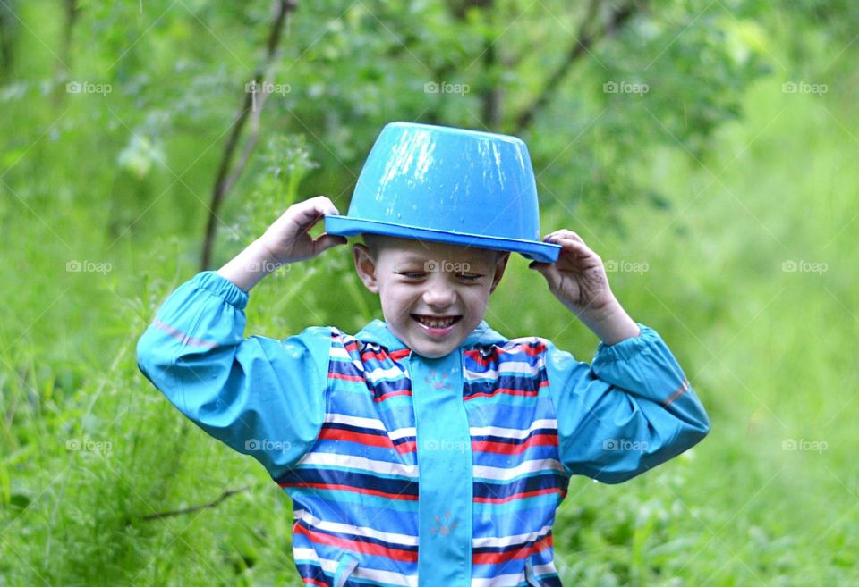 Children Playing in Rainy Spring Day with Buckets on Their Heads