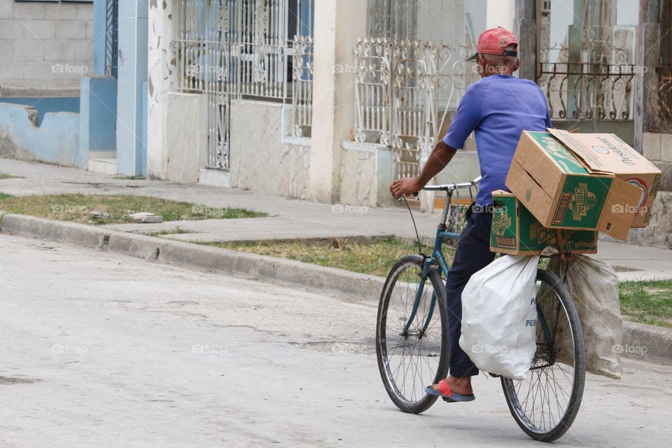 Cuban People.Cans and bottles collector on bike.