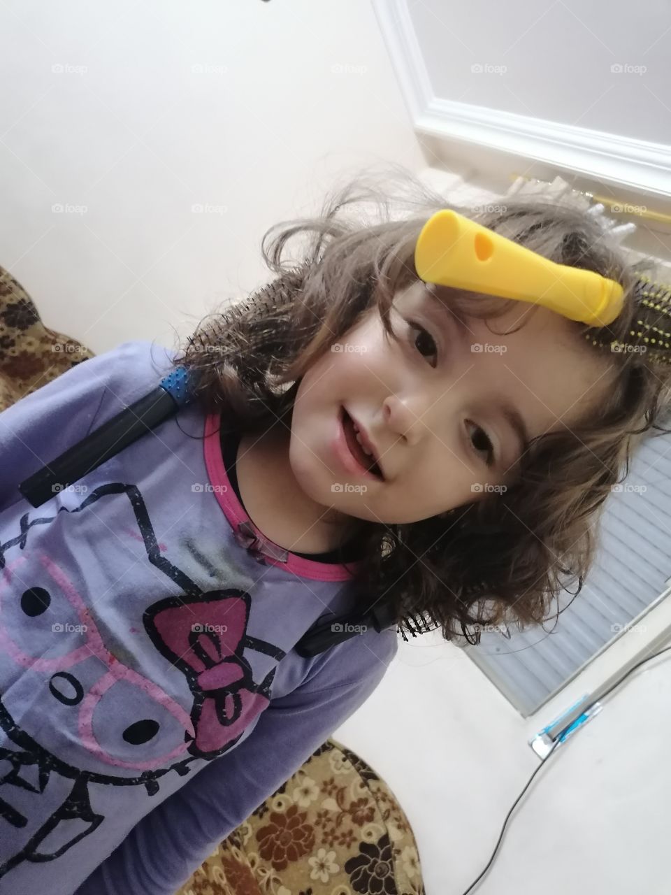 A girl stuck with a hair comb