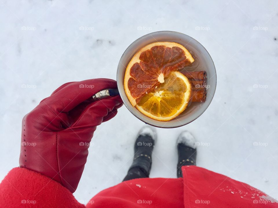 Person holding cup of tea