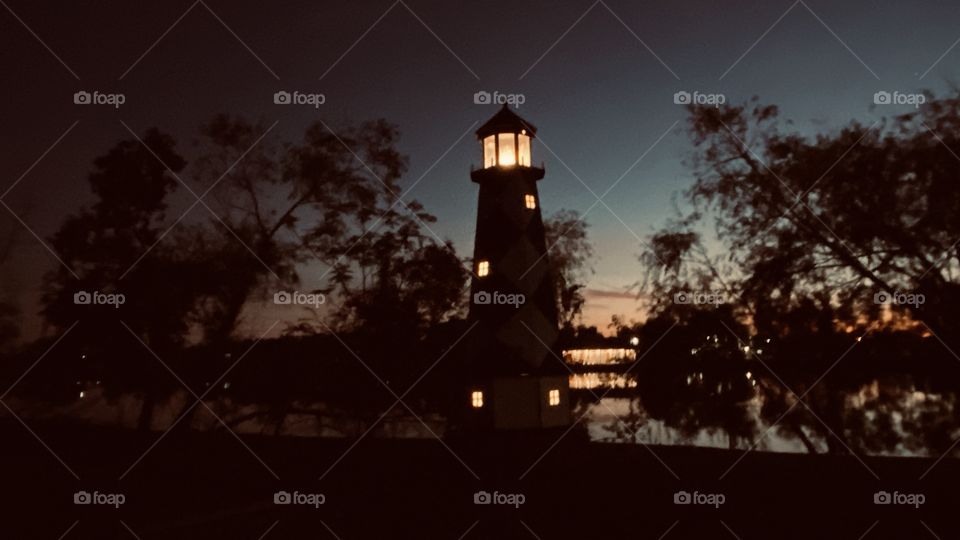 Lighthouse is Gleaming through the trees people are taking an evening walk along the lakeside and the mosquitoes are having a blast.