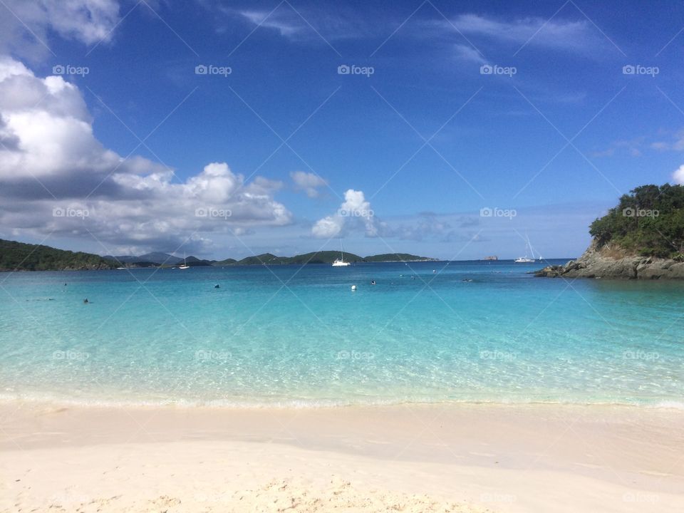 Soft sandy Caribbean beach, blue sky and crystal clear water 