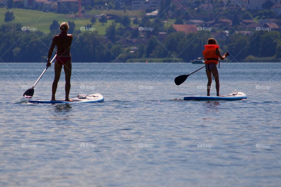 People Having Fun At Lake In Summer