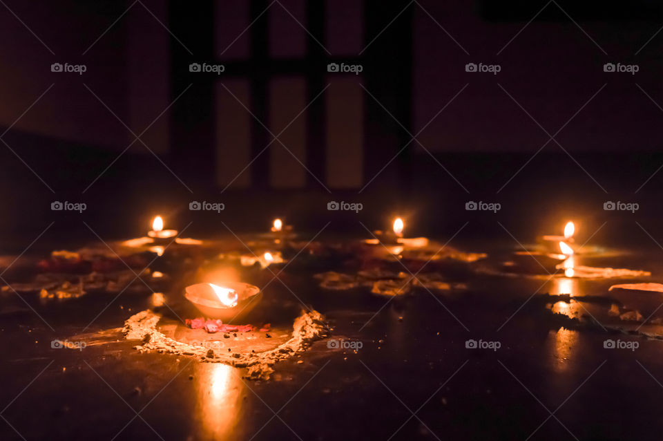 Happy Diwali. Diya Oil Lamps in DIPAWALI celebration decorated over Handmade Rangoli.