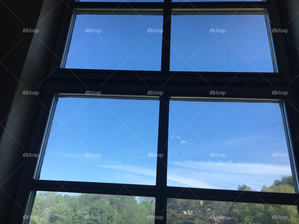 Blue sky and some clouds watched through windows