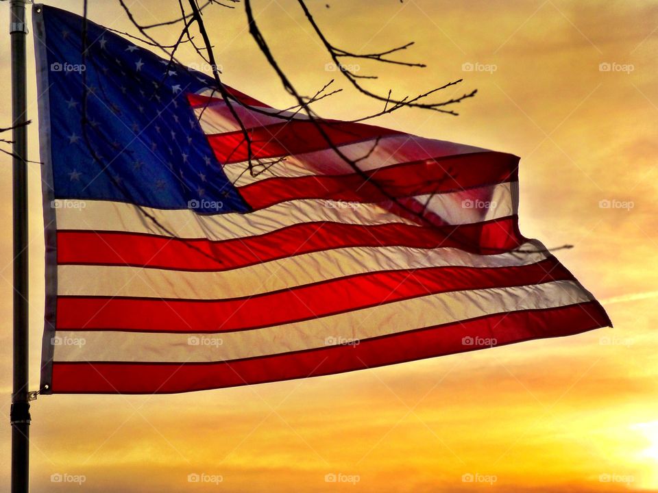 American flag flying at sunset