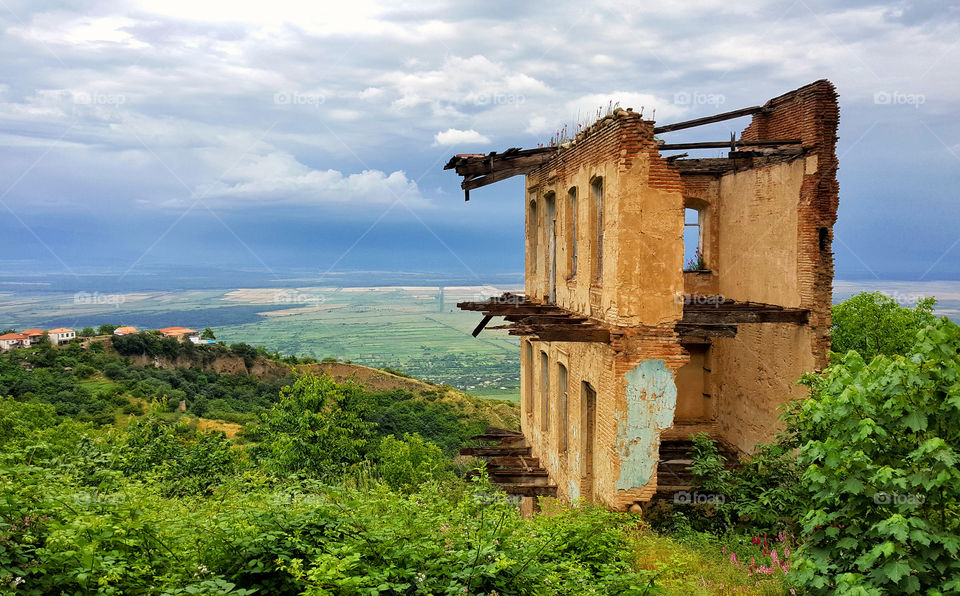 the abandoned building on the picturesque landscape background