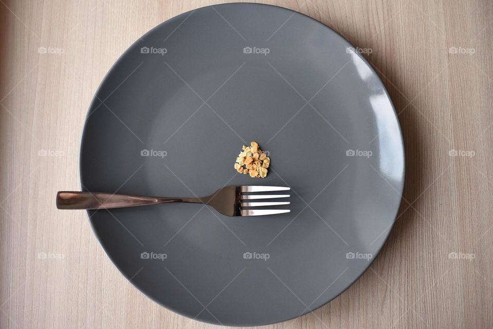metal fork on a gray plate with oatmeal