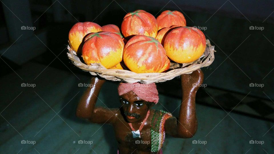Earthen art. Man going to sell fruits to market
