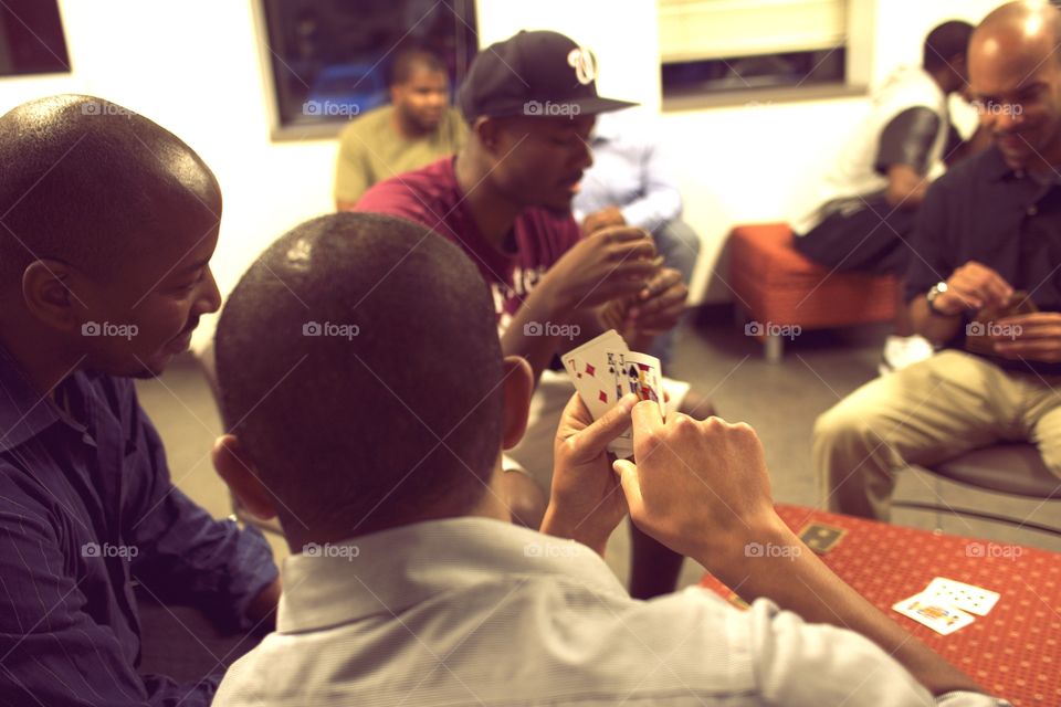 Card Game. Guys enjoy a game of cards. 