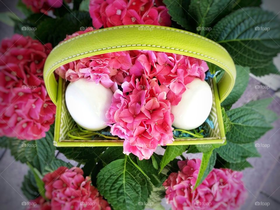 Pink hydrangea with a green easter basket with white eggs