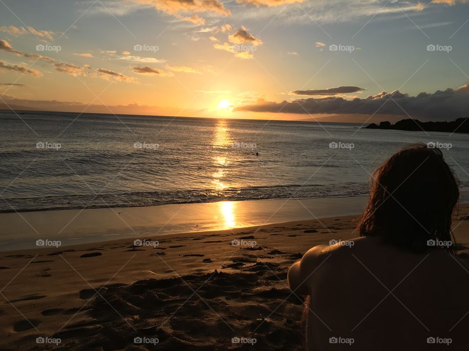 Rear view of a man sitting on beach