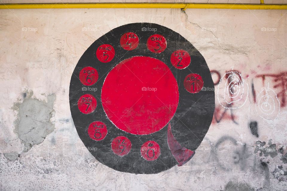 Phone disk painted on an old wall