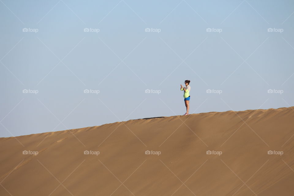 girl on top of dune 7. trip to Walvis Bay Namibia