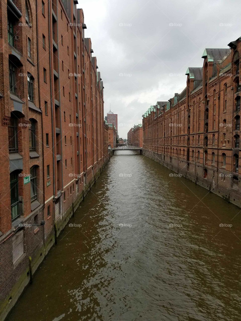 long view of commercial canals and brick buildings in Hamburg, Germany