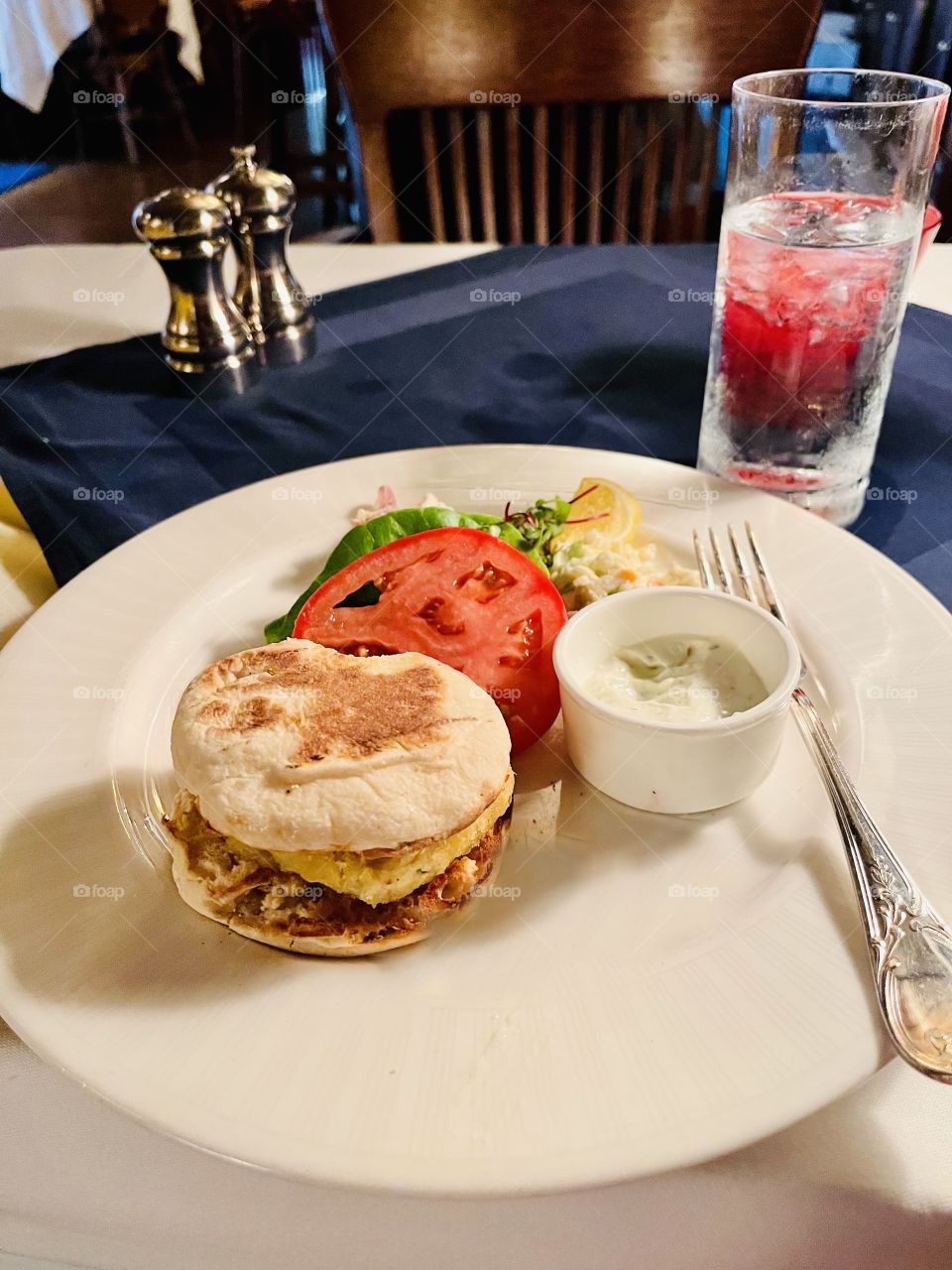 Lunch fare - Delicious crab cake burger with sides of tomato, and lettuce. Yum. 