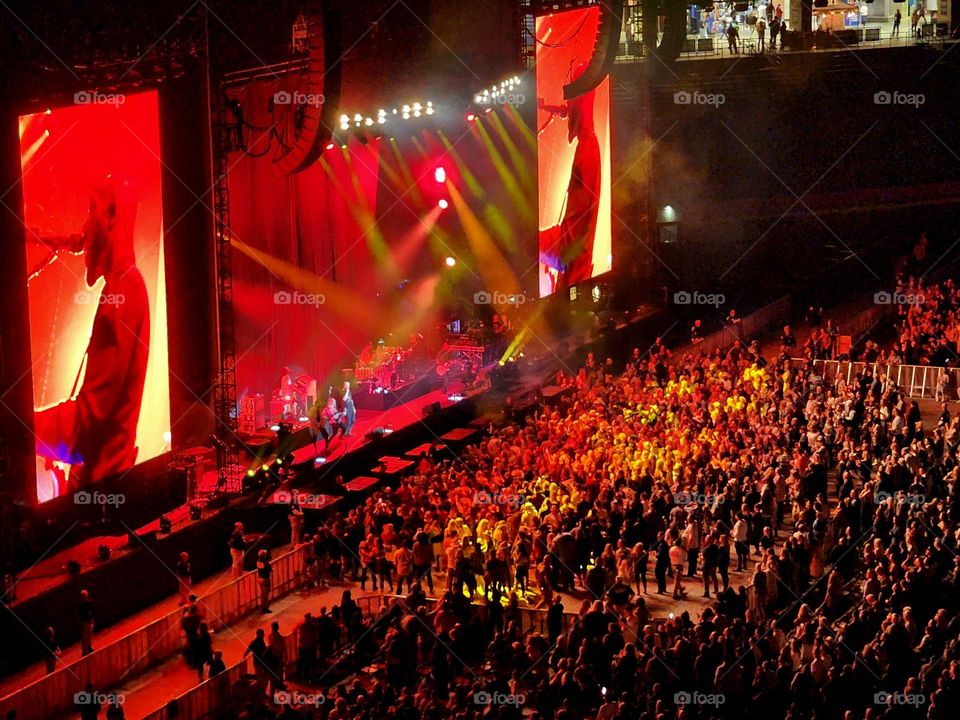 Fans crowd the stage of a popular musical act while on the final leg of their United States tour
