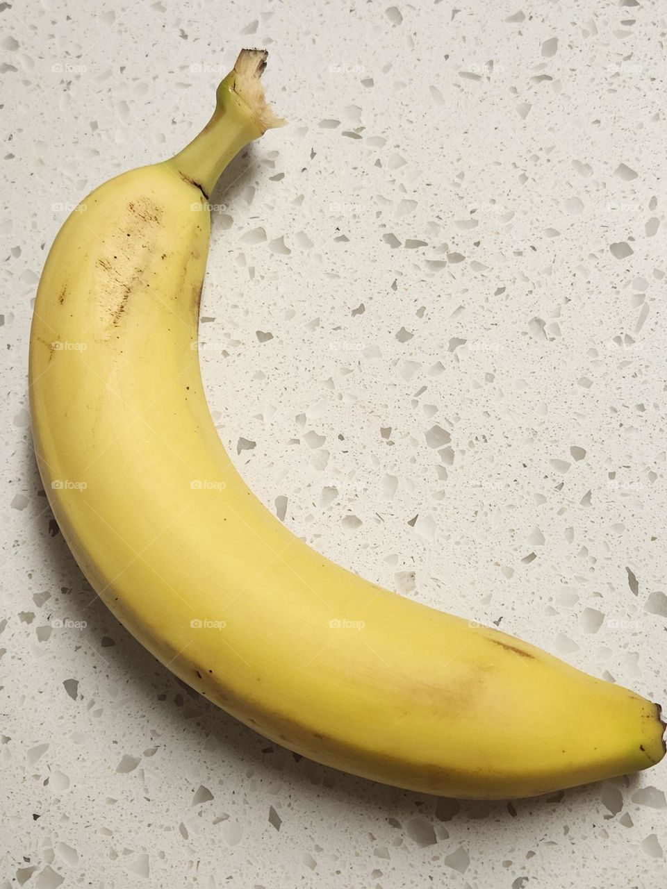 ripe yellow banana on kitchen countertop