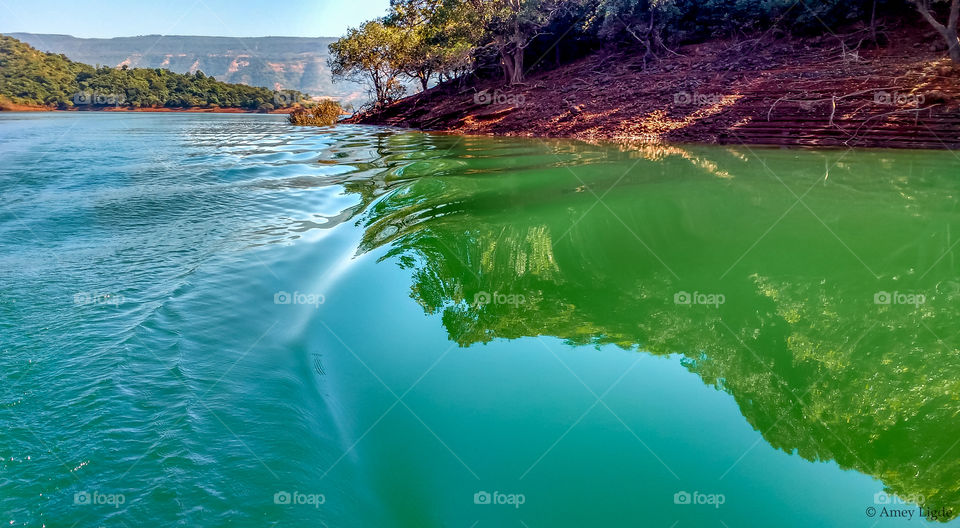 Cliff reflecting on lake