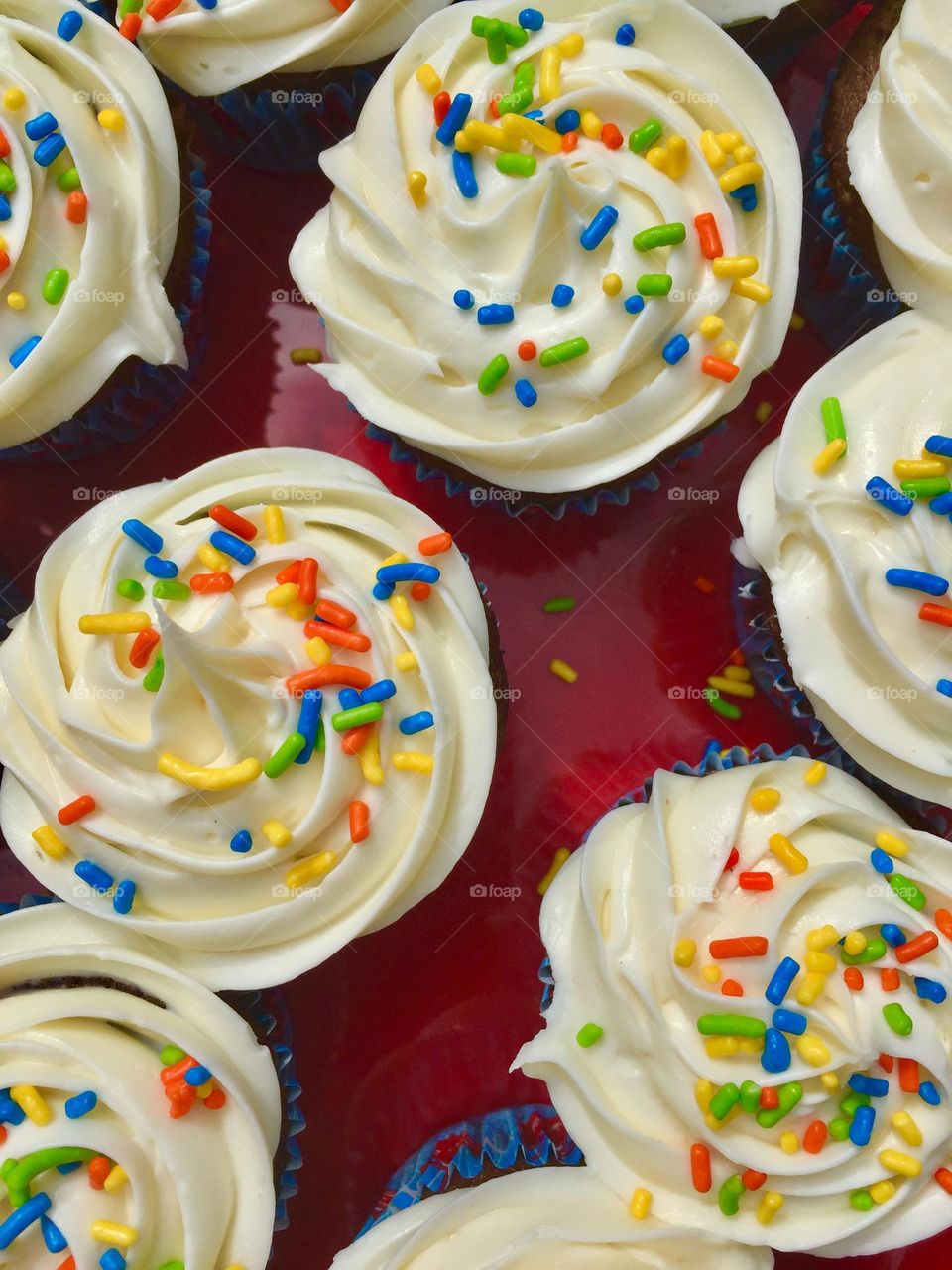 Cupcakes with vanilla frosting and sprinkles 