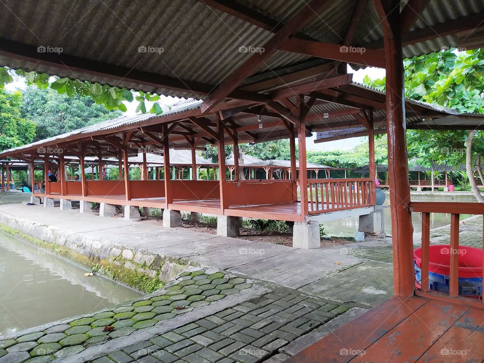 Traditional cafe with gazebo shape in Indonesia is called Saung. Lined with fishing ponds around.