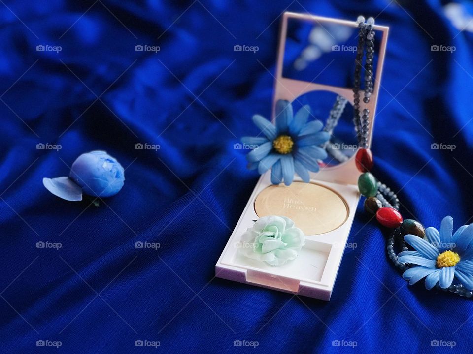 Blue heaven beauty product on blue satin cloth 