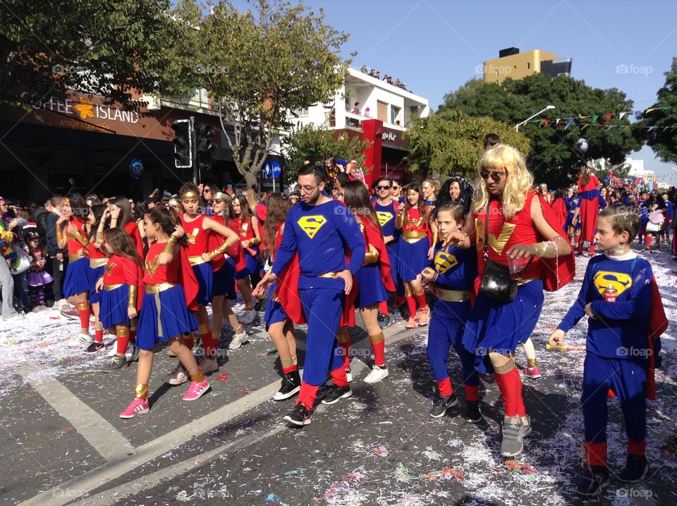 People in costume walking in carnival parade.