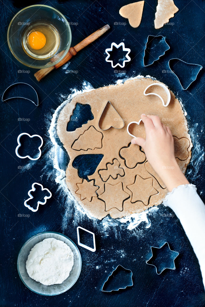 Woman's hand preparing gingerbread cookie