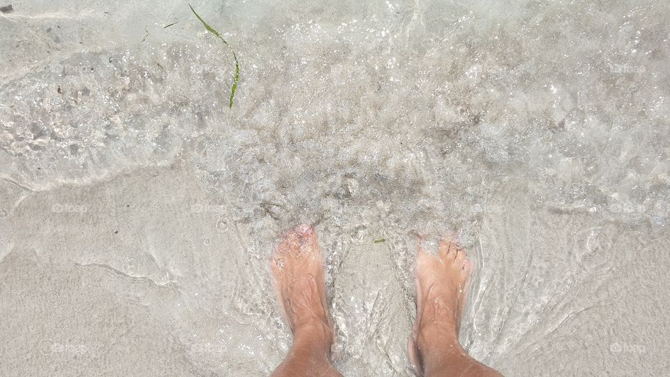 standing in the water , just relaxing