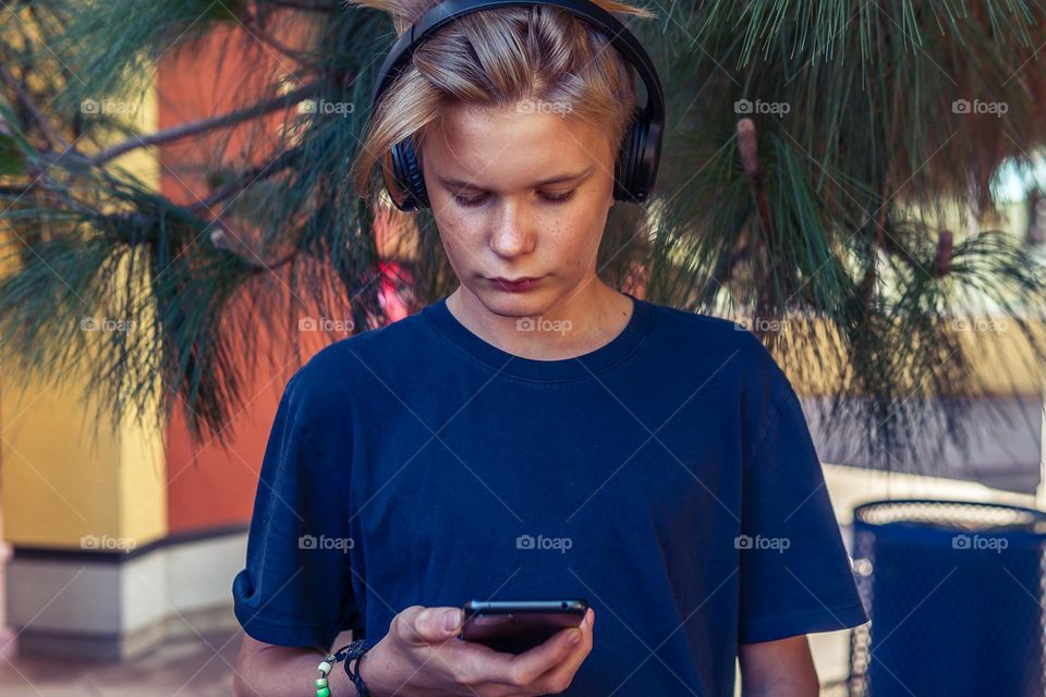 boy listening to the music on his phone