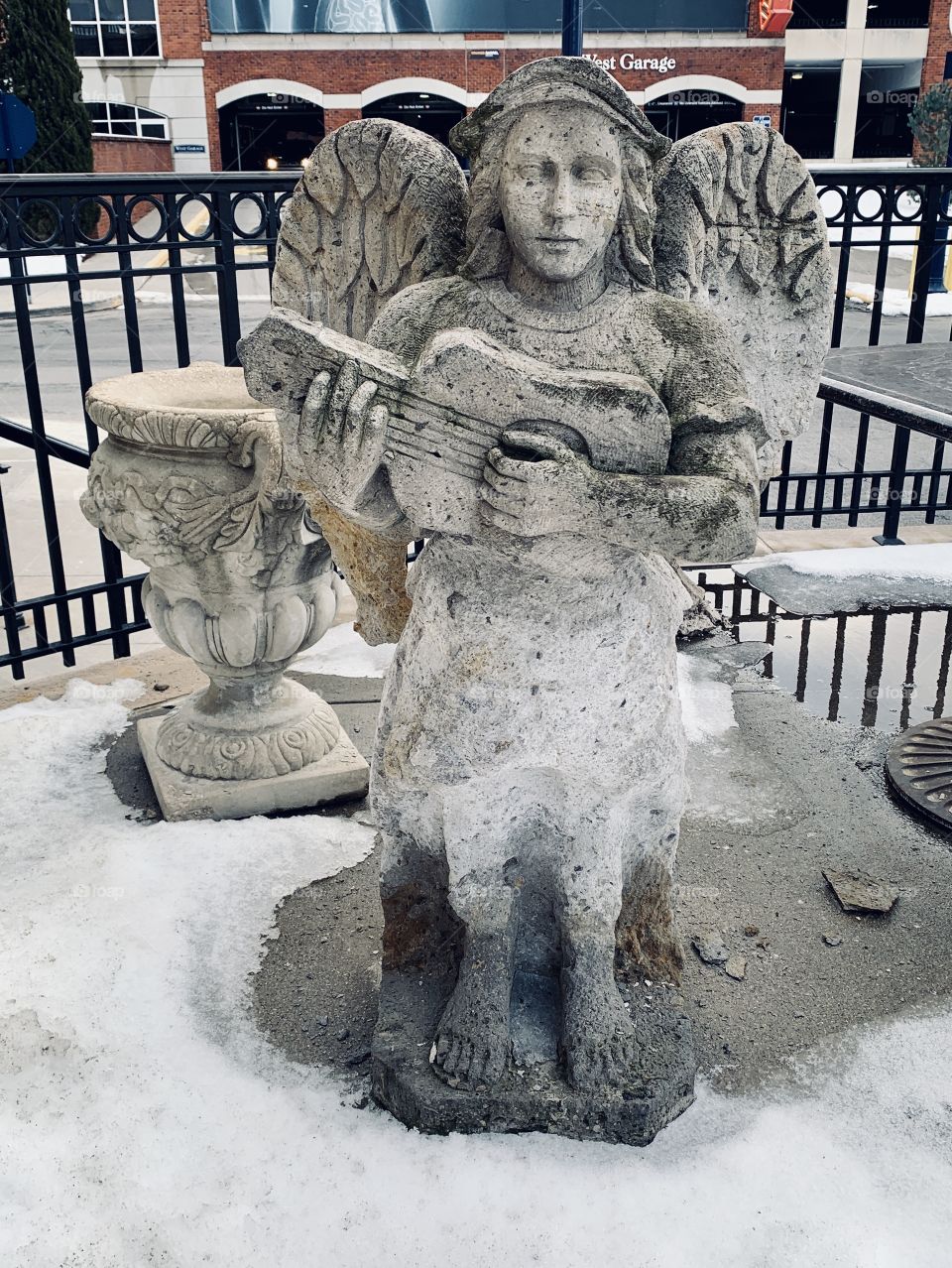A small Angel statue stands outside of a local restaurant that has since closed up shop. 
