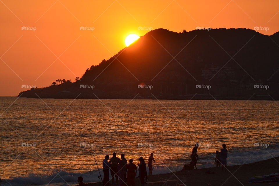 sunset in Alanya turkey over fishermen on the beach