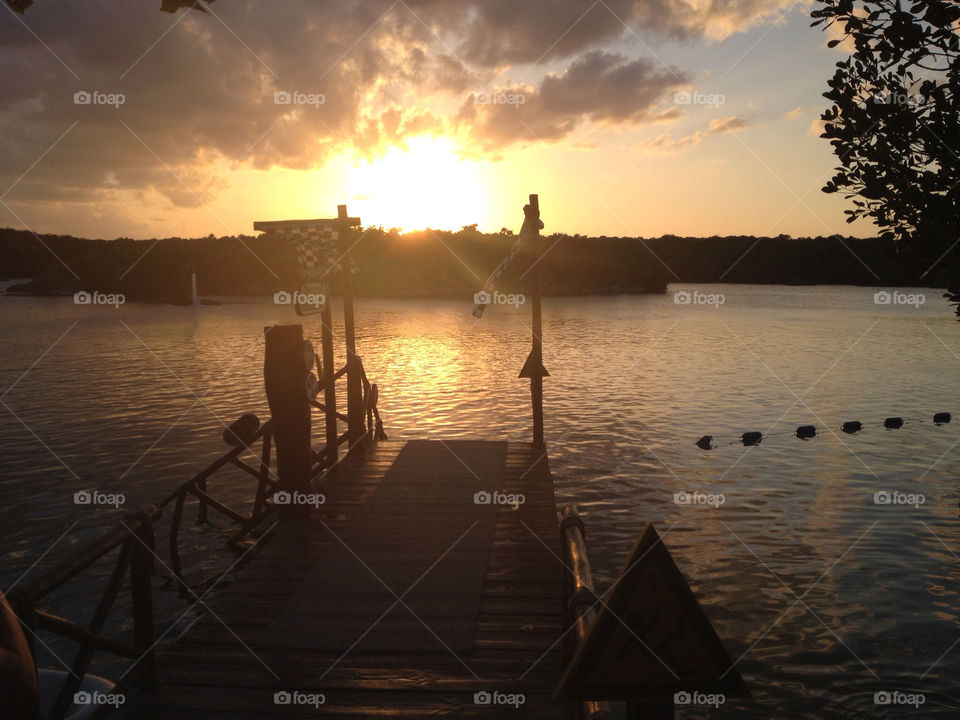 xel ha sunset silhouette pier by bourneweb