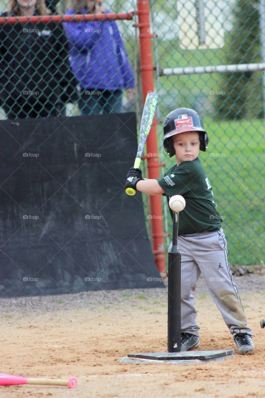 The look of focus and determination before he swings the bat and hits the ball off of the Tee. 