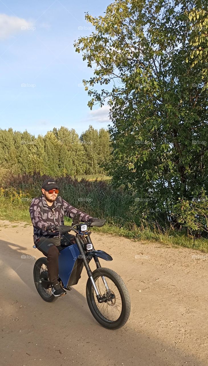 men on a electric motorcycle, summer time