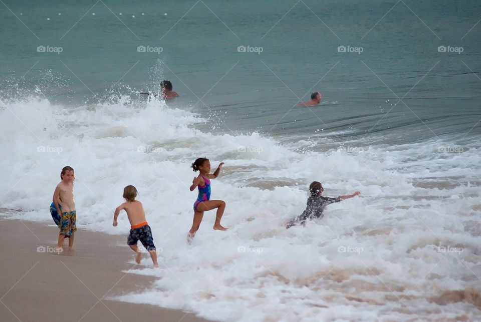 Children playing in the surf