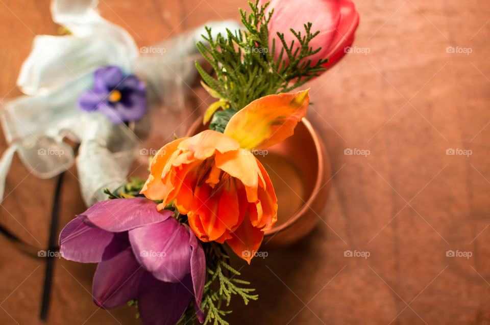 Rainbow flower garland on wood table with taffeta ribbon 
