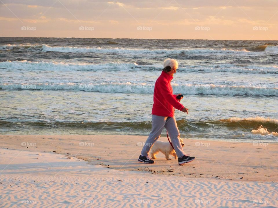 walking our dogs alone the beach on a warm summer 
