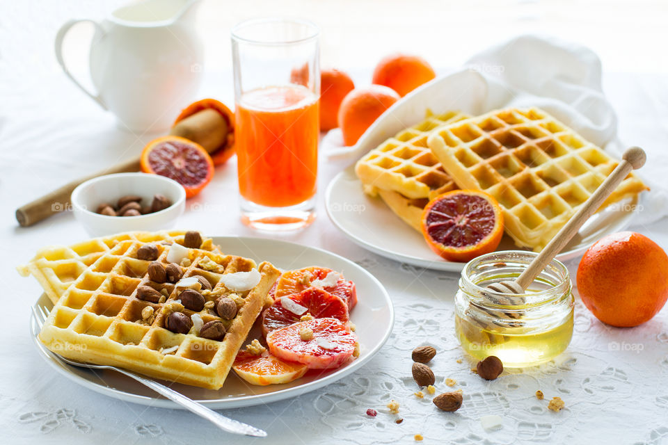 Healthy breakfast. Belgian waffles with blood orange, nuts and coconut