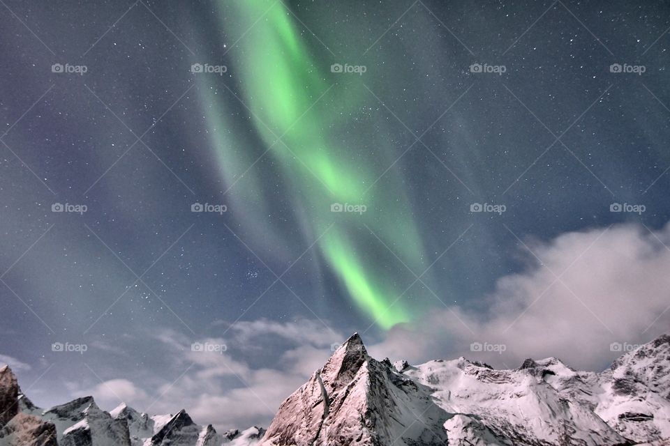 Northern Lights over the snowy mountains
