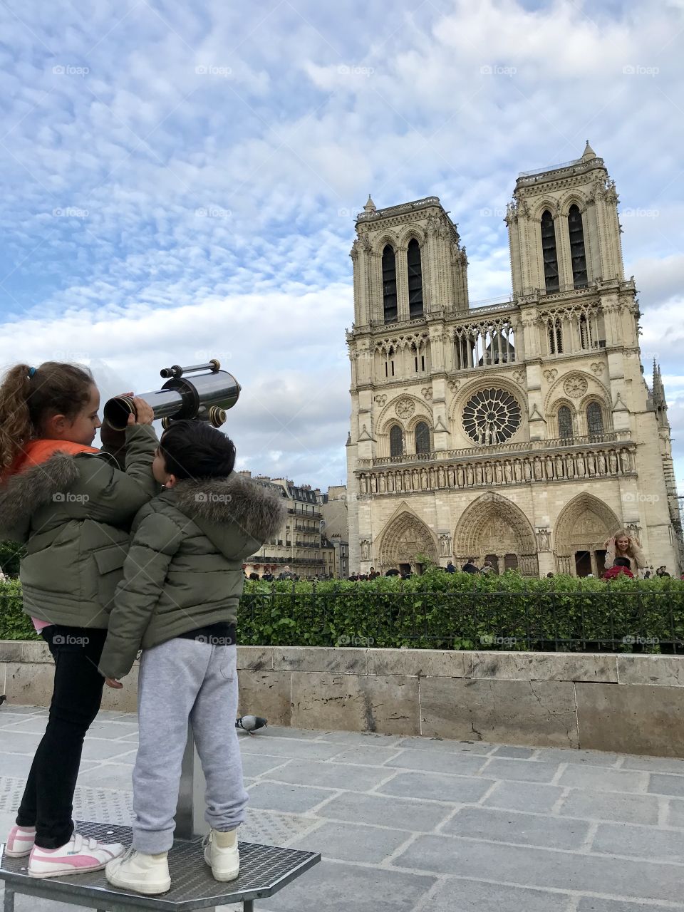 Discovering Paris. Kids looking at Notre-Dame de Paris Cathedral 