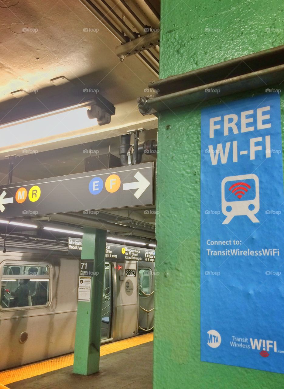 Wifi notice in nyc subway station with train
