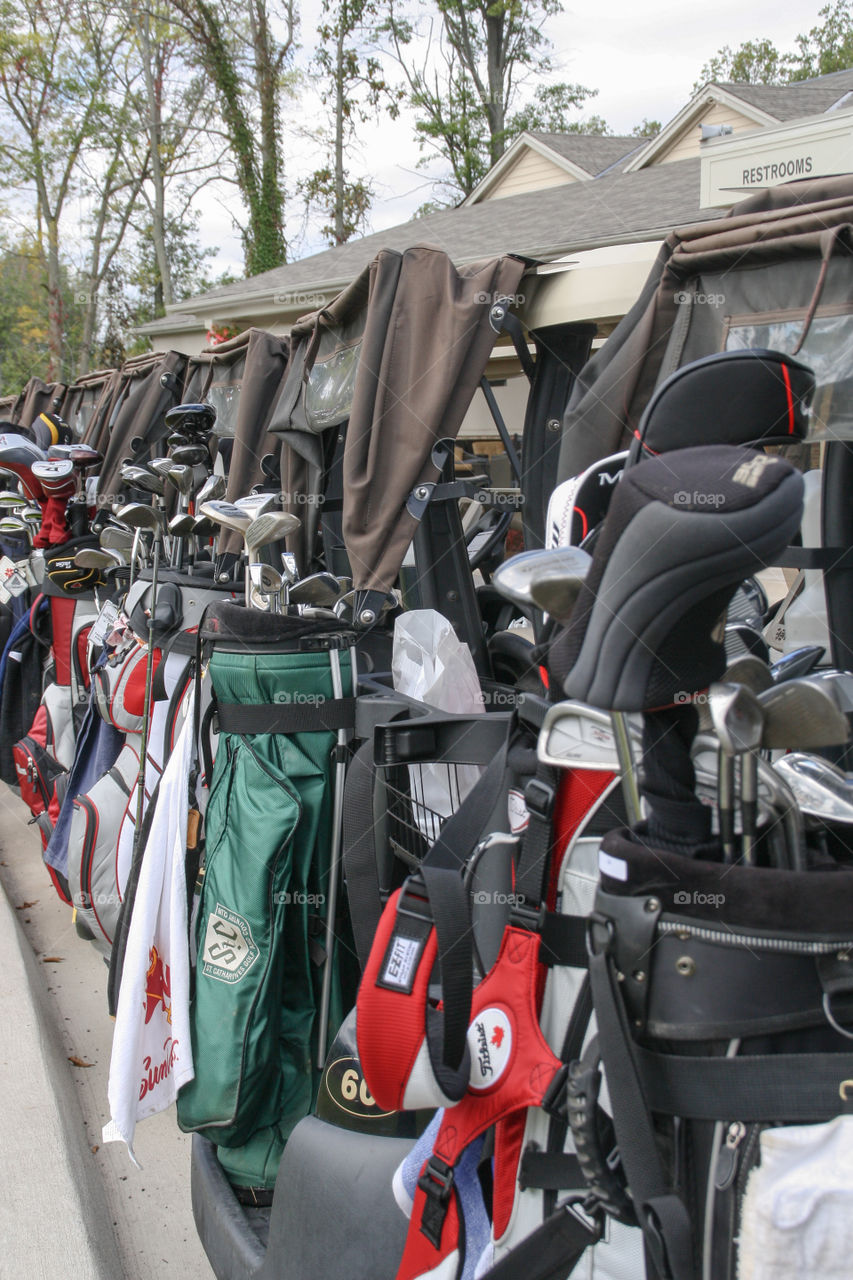 A row of golf carts and bags