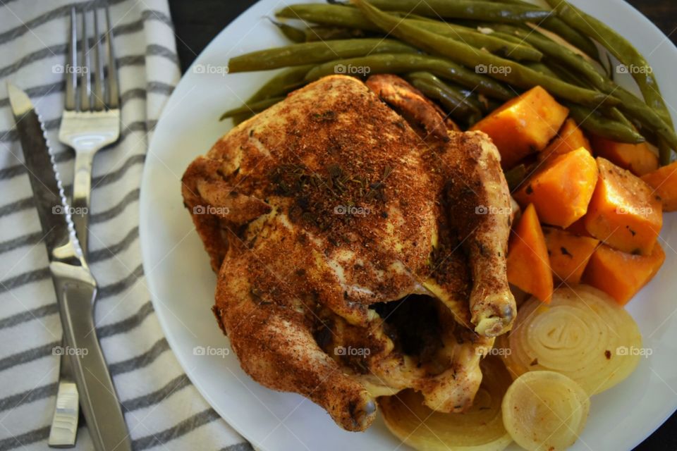 Spice-rubbed Cornish hen with sweet potatoes, green beans and onions