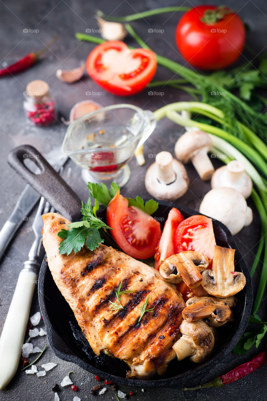 High angle view of chicken breasts with vegetables