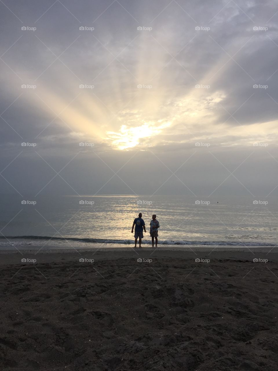 Bonding at Sunrise. Family went to beach to watch the sunrise...no sun, but lots of fun. Brother-in laws in deep conversation. 